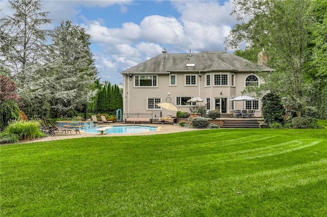 rear view of house with a lawn and a patio area