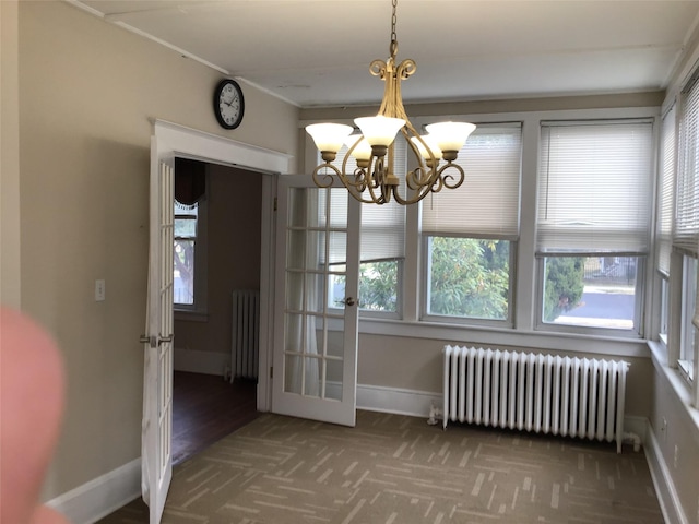 unfurnished dining area featuring radiator heating unit, dark carpet, and a notable chandelier