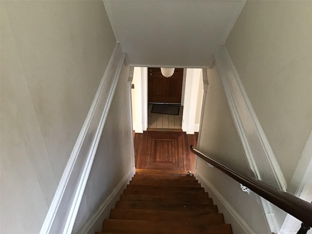 stairs featuring hardwood / wood-style flooring