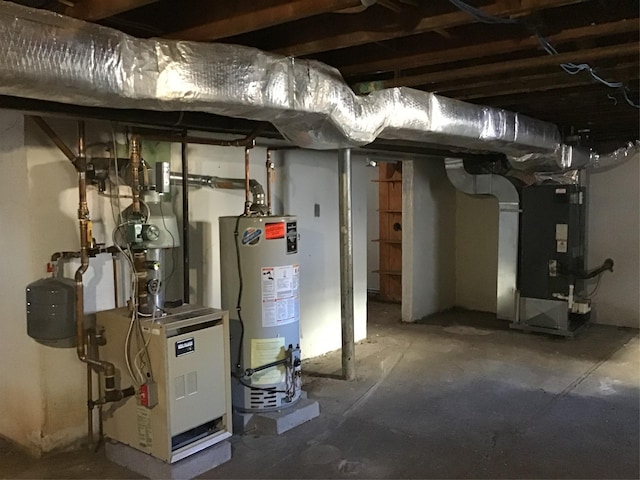 utility room featuring electric panel and water heater