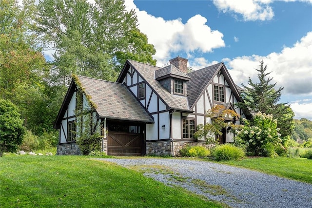 tudor home featuring a front lawn