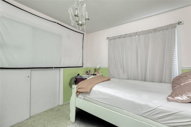 carpeted bedroom featuring a notable chandelier