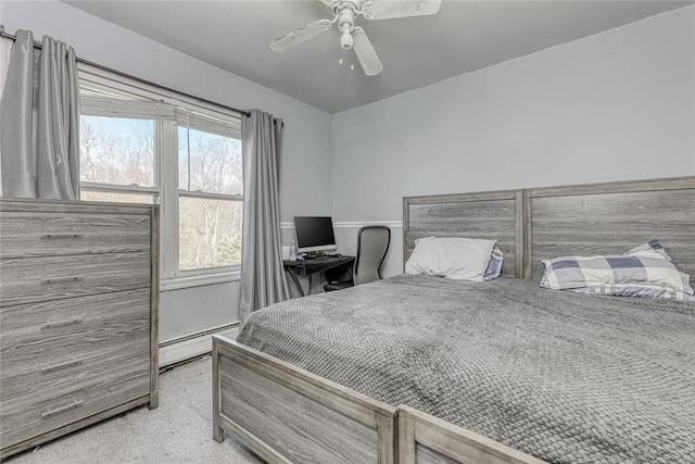 bedroom featuring ceiling fan, light colored carpet, and a baseboard radiator