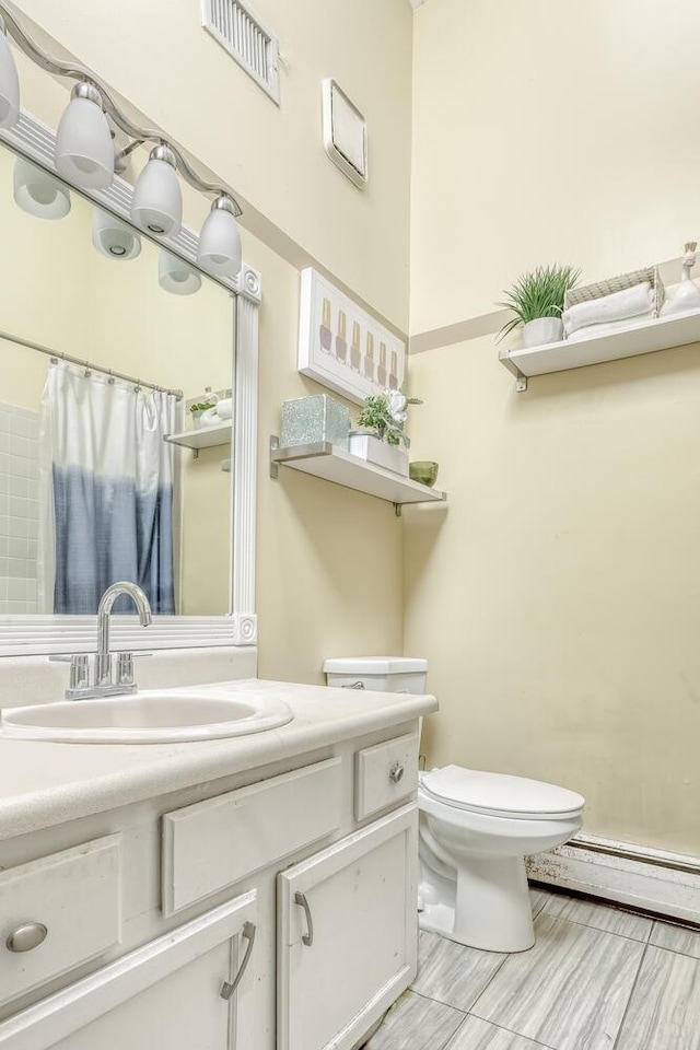 bathroom featuring vanity, toilet, and a baseboard radiator