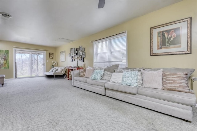 carpeted living room with a wealth of natural light and ceiling fan