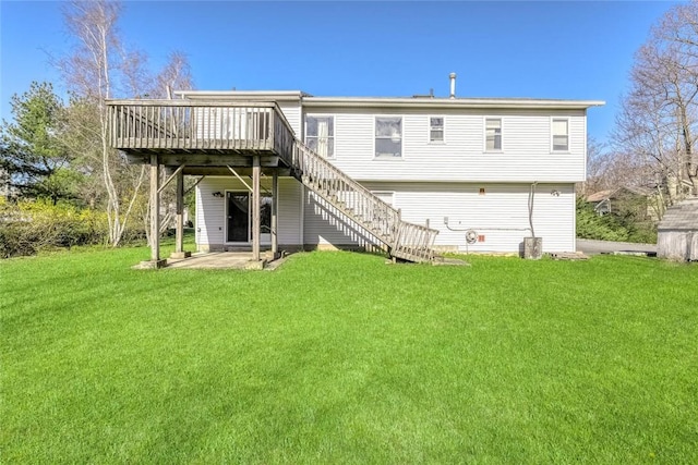 rear view of property with a yard, a patio, and a deck