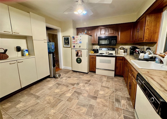 kitchen featuring white appliances, ceiling fan, and sink