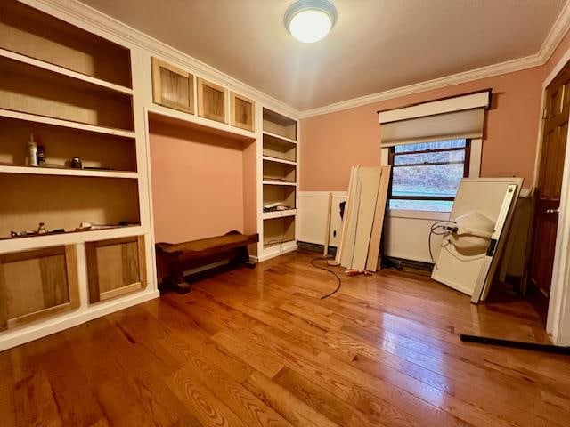 interior space featuring hardwood / wood-style flooring and ornamental molding