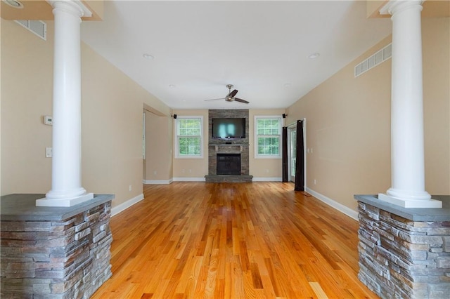 unfurnished living room with hardwood / wood-style floors, ceiling fan, and a fireplace