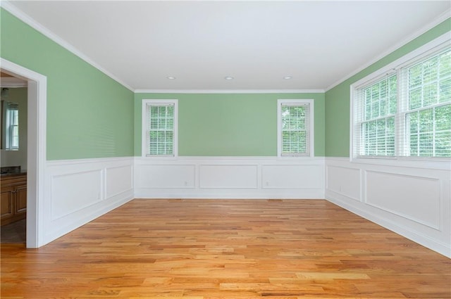 unfurnished room with light hardwood / wood-style flooring and crown molding