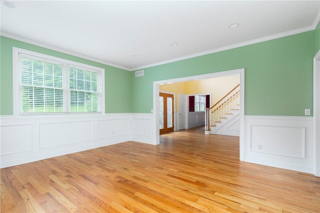 unfurnished room with crown molding and light wood-type flooring