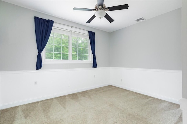 carpeted spare room with ceiling fan