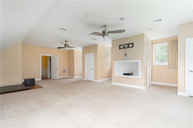 unfurnished living room with lofted ceiling and light carpet