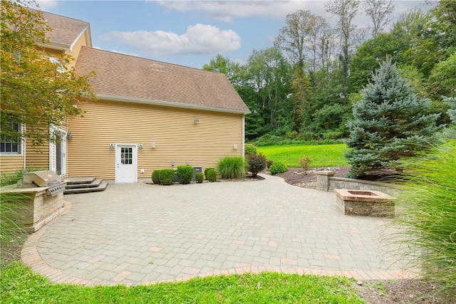 view of patio featuring a fire pit and a grill