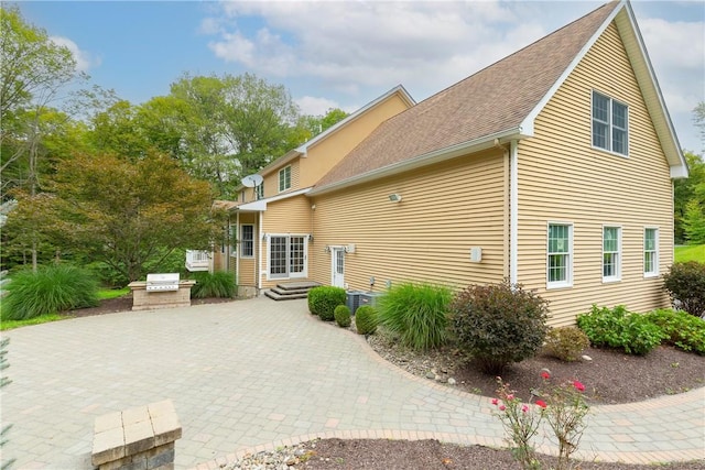 view of property exterior featuring area for grilling