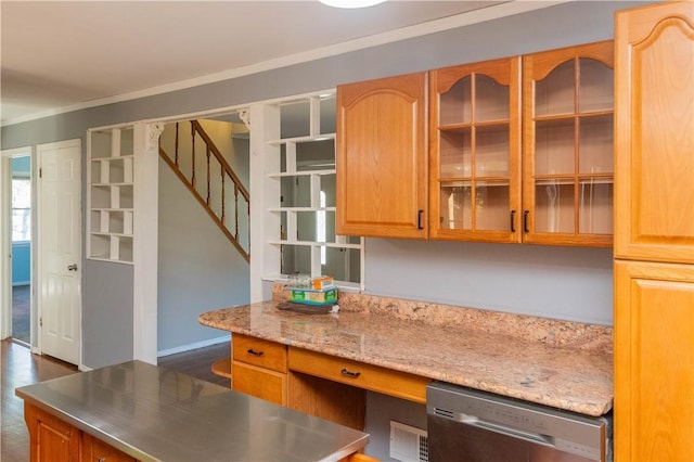 kitchen featuring light stone countertops, built in desk, stainless steel dishwasher, and ornamental molding