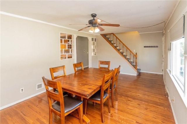 dining room with light hardwood / wood-style flooring, ceiling fan, and ornamental molding