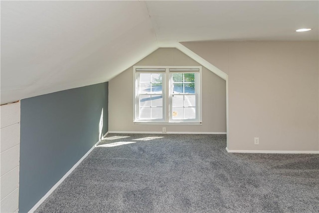 additional living space with carpet flooring and vaulted ceiling