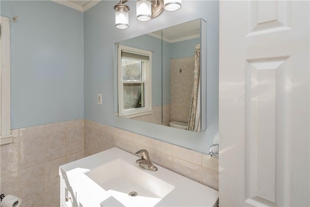 bathroom with toilet, ornamental molding, and sink