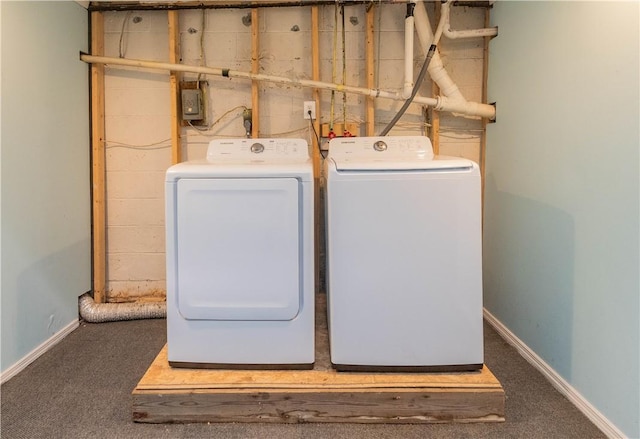 clothes washing area with dark colored carpet and independent washer and dryer