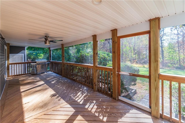 wooden terrace with a shed and ceiling fan