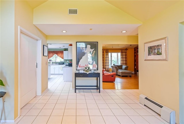 hallway featuring light wood-type flooring and a baseboard radiator