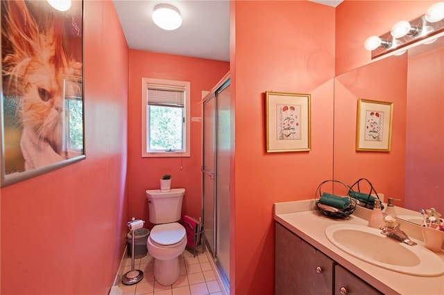 bathroom featuring tile patterned flooring, vanity, toilet, and an enclosed shower