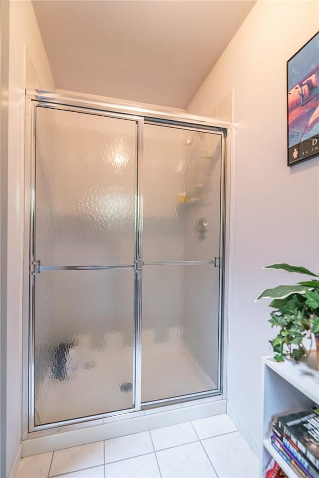 bathroom featuring tile patterned floors and a shower with shower door