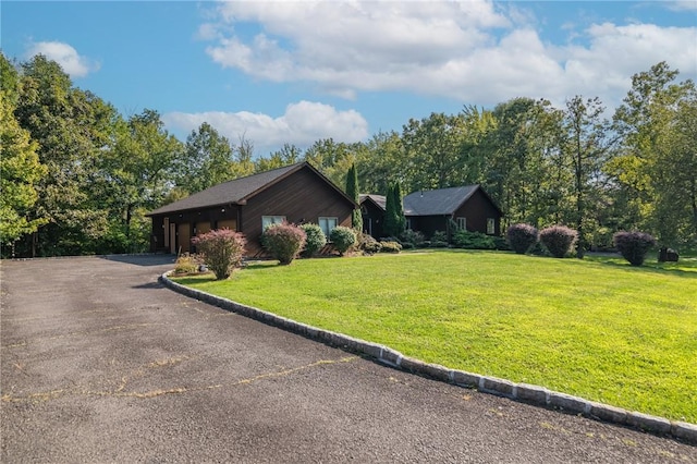 view of property exterior with a yard