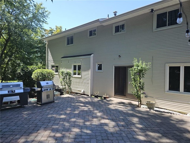 rear view of property featuring a patio area