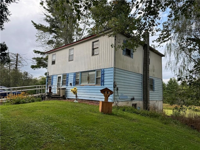 rear view of property featuring a yard