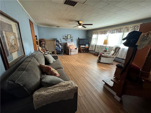 living room with hardwood / wood-style flooring and ceiling fan