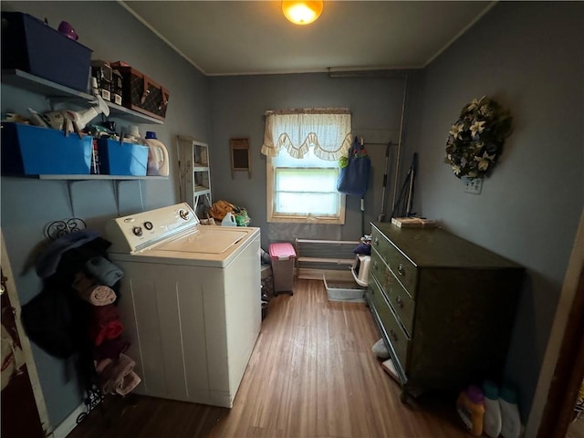 laundry area with hardwood / wood-style flooring, crown molding, and washer / clothes dryer