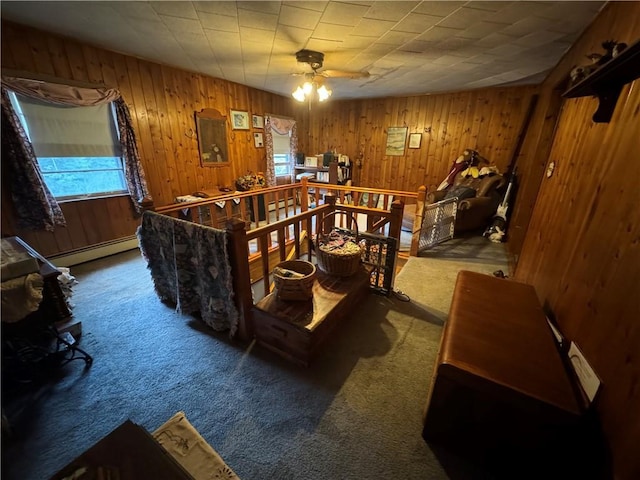 3038 State Route 17b, Cochecton, NY 12726 - carpeted living room featuring a baseboard radiator, healthy amount of natural light, wooden walls, and a ceiling fan