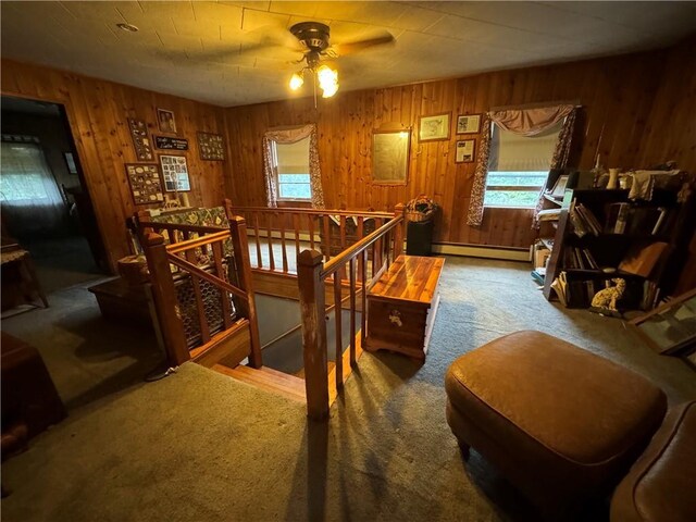 3038 State Route 17b, Cochecton, NY 12726 - carpeted living room featuring a baseboard heating unit, ceiling fan, and wooden walls