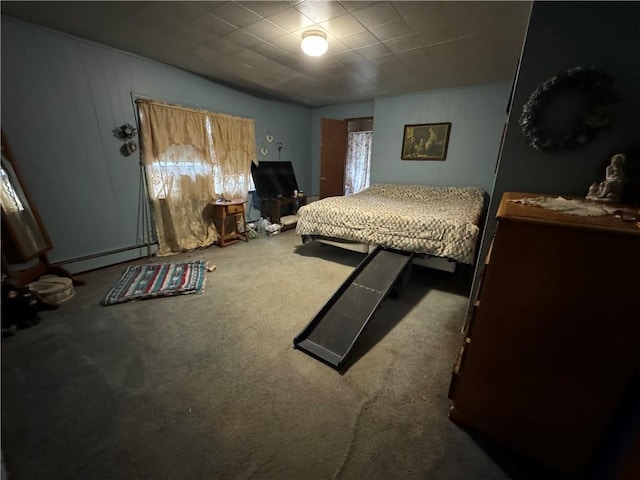 carpeted bedroom featuring a baseboard heating unit