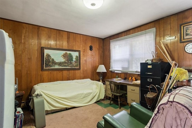 carpeted bedroom featuring wood walls