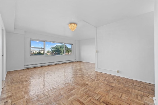 spare room featuring light parquet flooring and a baseboard heating unit