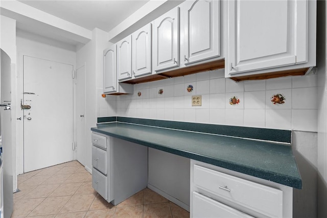 kitchen featuring white cabinetry, backsplash, and light tile patterned floors