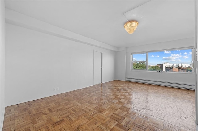 unfurnished room with light parquet floors and a baseboard heating unit