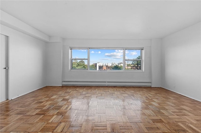 empty room featuring light parquet flooring and a baseboard radiator