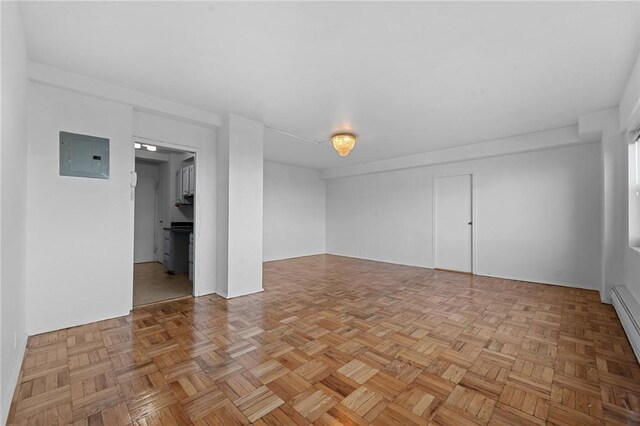 spare room with light parquet flooring and electric panel