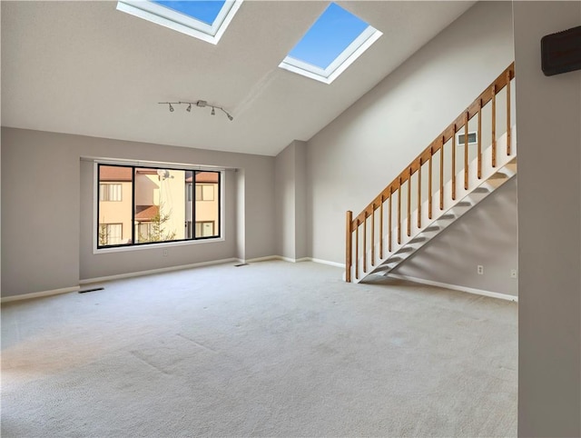 unfurnished living room with light carpet and high vaulted ceiling