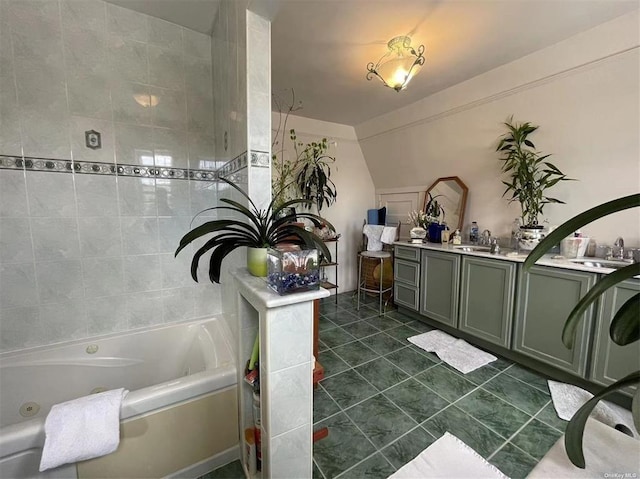 bathroom featuring tile patterned flooring, vanity, and a washtub