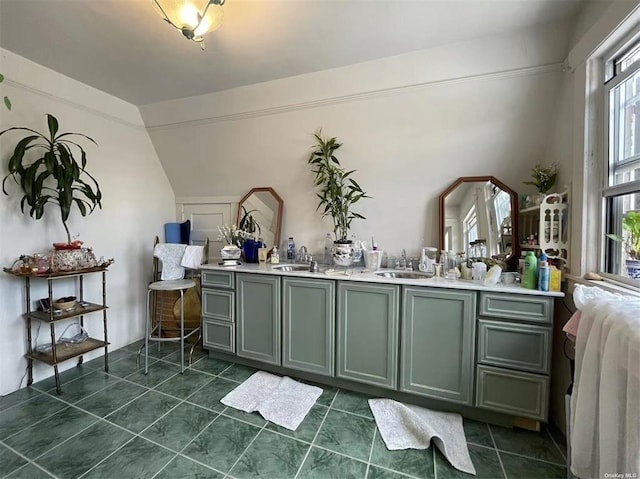 bathroom with tile patterned flooring, vanity, and lofted ceiling