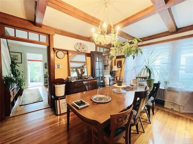 dining space with beamed ceiling, light hardwood / wood-style floors, coffered ceiling, and a notable chandelier