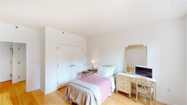 bedroom featuring light hardwood / wood-style floors and a closet