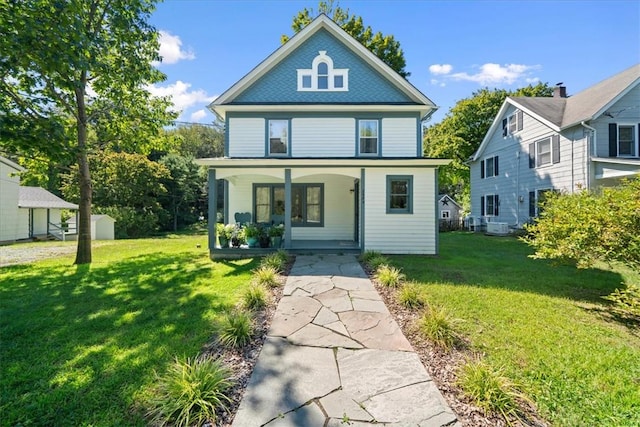 view of front facade with covered porch and a front yard