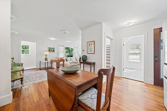 dining area featuring a wealth of natural light and light hardwood / wood-style flooring