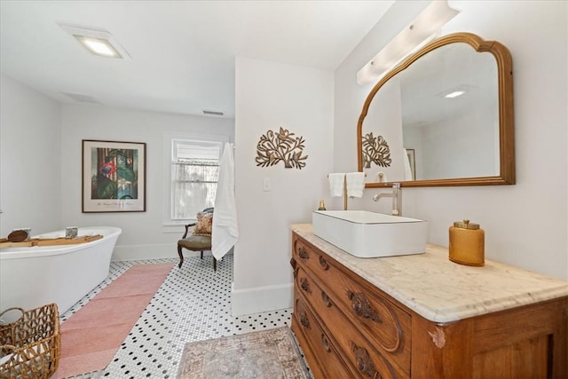 bathroom featuring vanity and a tub